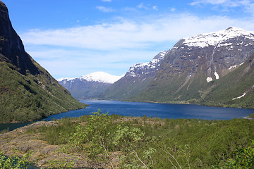 Image showing A beautiful spring day with snow on the mountain peaks, blue sky