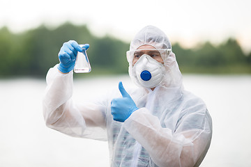 Image showing Chemist with test-tube , blurred background