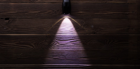 Image showing Included flashlight on wooden background