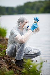 Image showing Chemist with test-tube and water