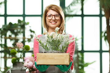 Image showing Happy girl . Focused on flowers.