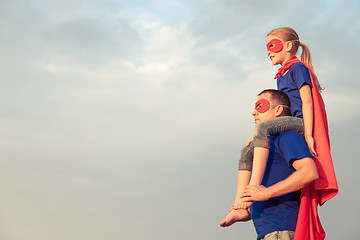 Image showing Father and daughter playing superhero at the day time. 