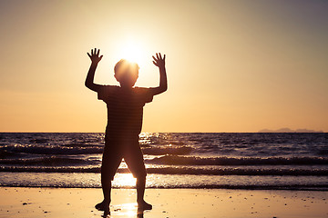 Image showing Happy little boy standing on the beach 