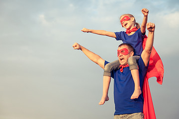 Image showing Father and daughter playing superhero at the day time.