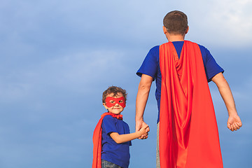 Image showing Father and son playing superhero at the day time. 