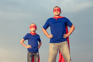 Image showing Father and daughter playing superhero at the day time.