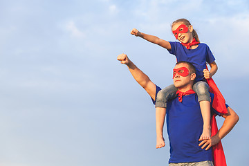 Image showing Father and daughter playing superhero at the day time.