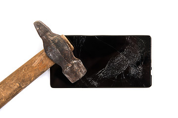 Image showing An old hammer and smartphone
