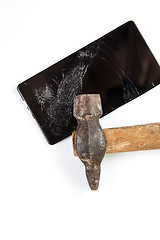 Image showing An old hammer and smartphone