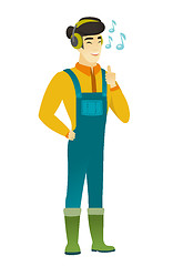Image showing Farmer listening to music in headphones.
