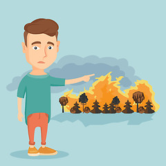 Image showing Man standing on the background of wildfire.