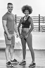 Image showing black woman after a workout at the gym with a trainer