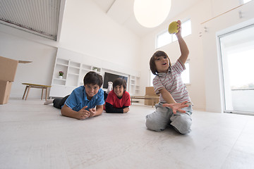 Image showing boys having fun with an apple on the floor