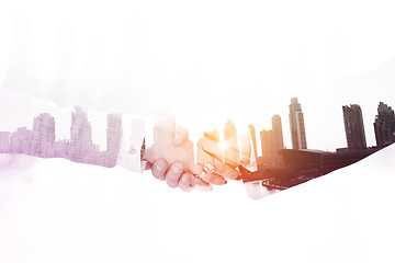 Image showing Double exposure business man and woman handshake on  meeting