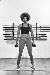 Image showing black woman doing bicep curls