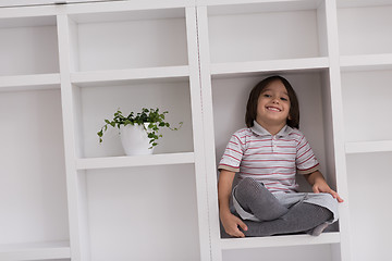 Image showing young boy posing on a shelf