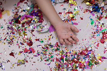 Image showing Children\'s hand with confetti in background