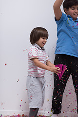 Image showing kids  blowing confetti