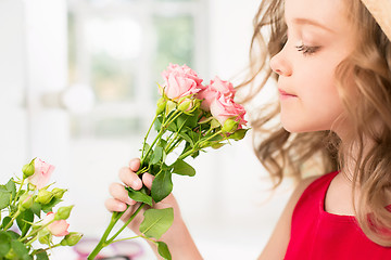 Image showing A little girl with roses
