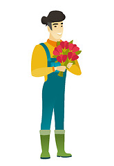 Image showing Asian farmer holding a bouquet of flowers