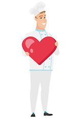 Image showing Caucasian chef cook holding a big red heart.