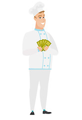 Image showing Happy caucasian chef cook holding money.