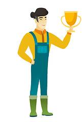 Image showing Asian farmer holding a golden trophy.