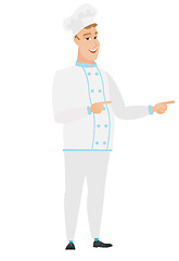 Image showing Young caucasian chef cook pointing to the side.