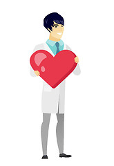 Image showing Asian doctor holding a big red heart.