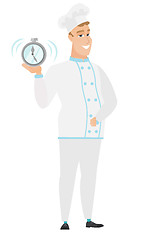 Image showing Caucasian chef cook holding alarm clock.