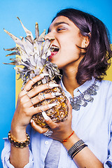 Image showing lifestyle people concept. young pretty smiling indian girl with pineapple, asian summer fruits 