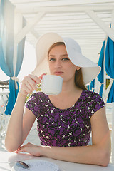 Image showing Model in summer outfit drinking coffee