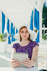 Image showing Stylish girl with gadgets in summer cage