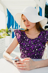 Image showing Elegant woman with coffee and smartphone