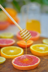 Image showing Grapefruit, clementine, orange and honey