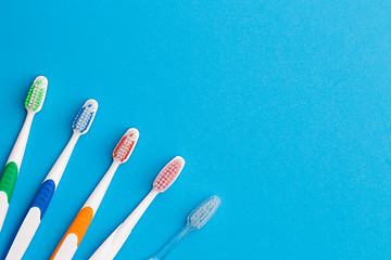 Image showing Five toothbrushes, place for words