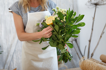 Image showing Girl makes bouquet with lemon