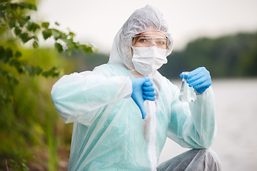 Image showing Biologist with bulb ,river bank