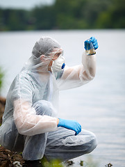 Image showing Chemist takes sample of water