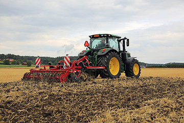 Image showing John Deere 6155R Tractor and Horsch Cultivator on Field