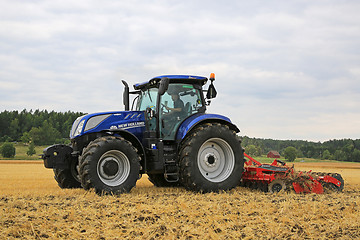 Image showing New Holland Tractor and Kverneland Disc Harrow on Stubble Field