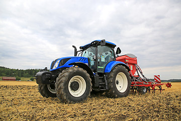 Image showing New Holland Tractor and Seed Drill on Field