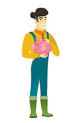 Image showing Asian farmer holding a piggy bank.