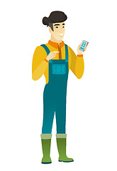 Image showing Asian farmer holding a mobile phone.