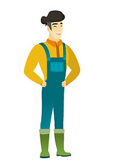 Image showing Young asian farmer in coveralls laughing.