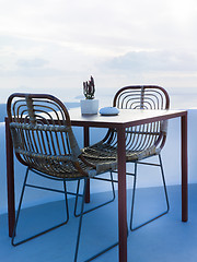 Image showing The two chairs and a small table on beautiful terrace with wonderful sea view