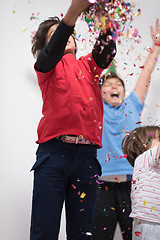 Image showing kids  blowing confetti