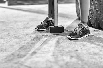 Image showing black woman after workout with hammer with focus on legs