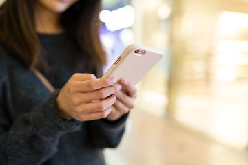 Image showing Woman sending text message on cellphone