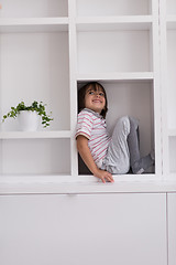 Image showing young boy posing on a shelf